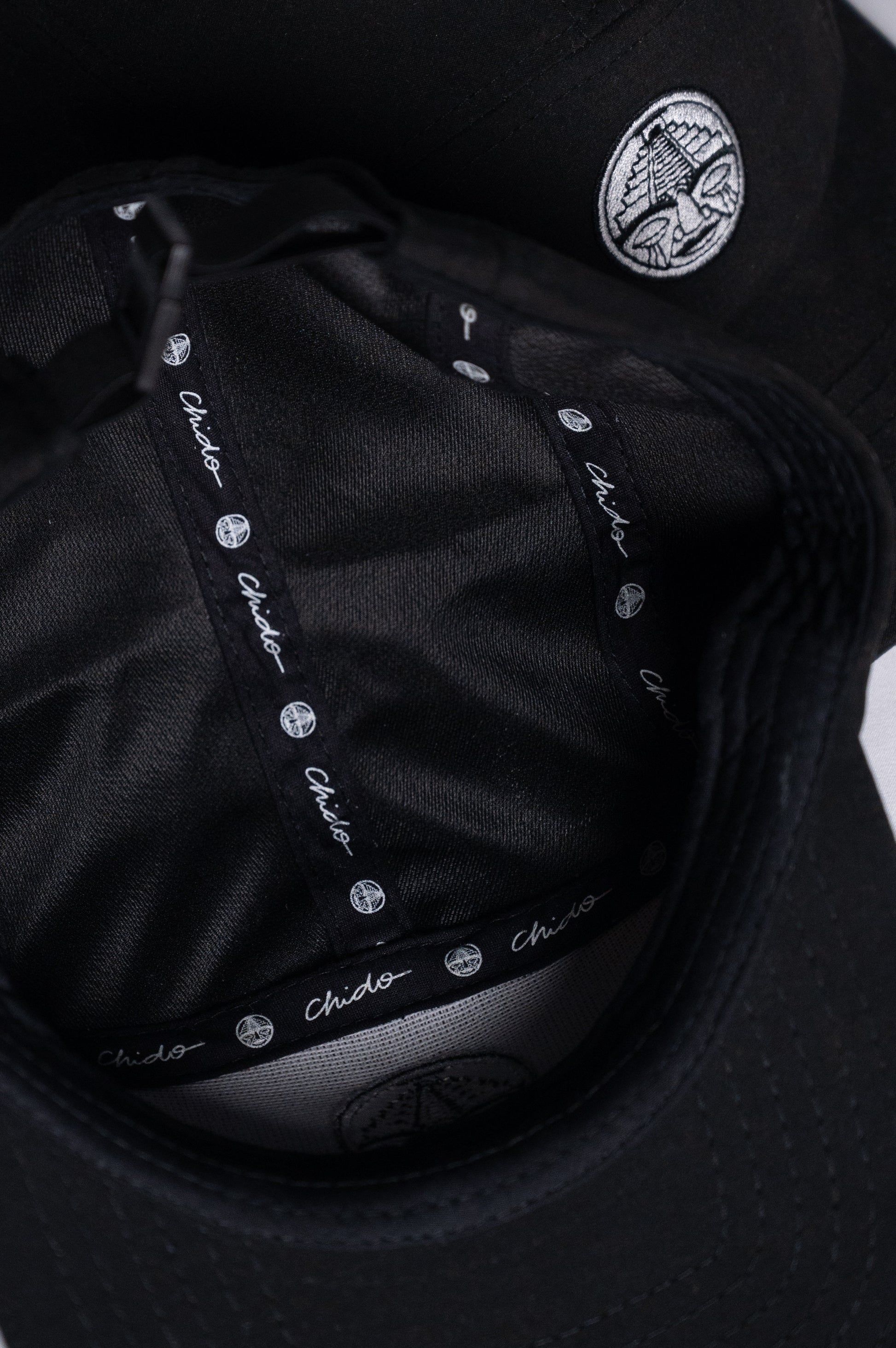 Black 5-panel cap. Chido