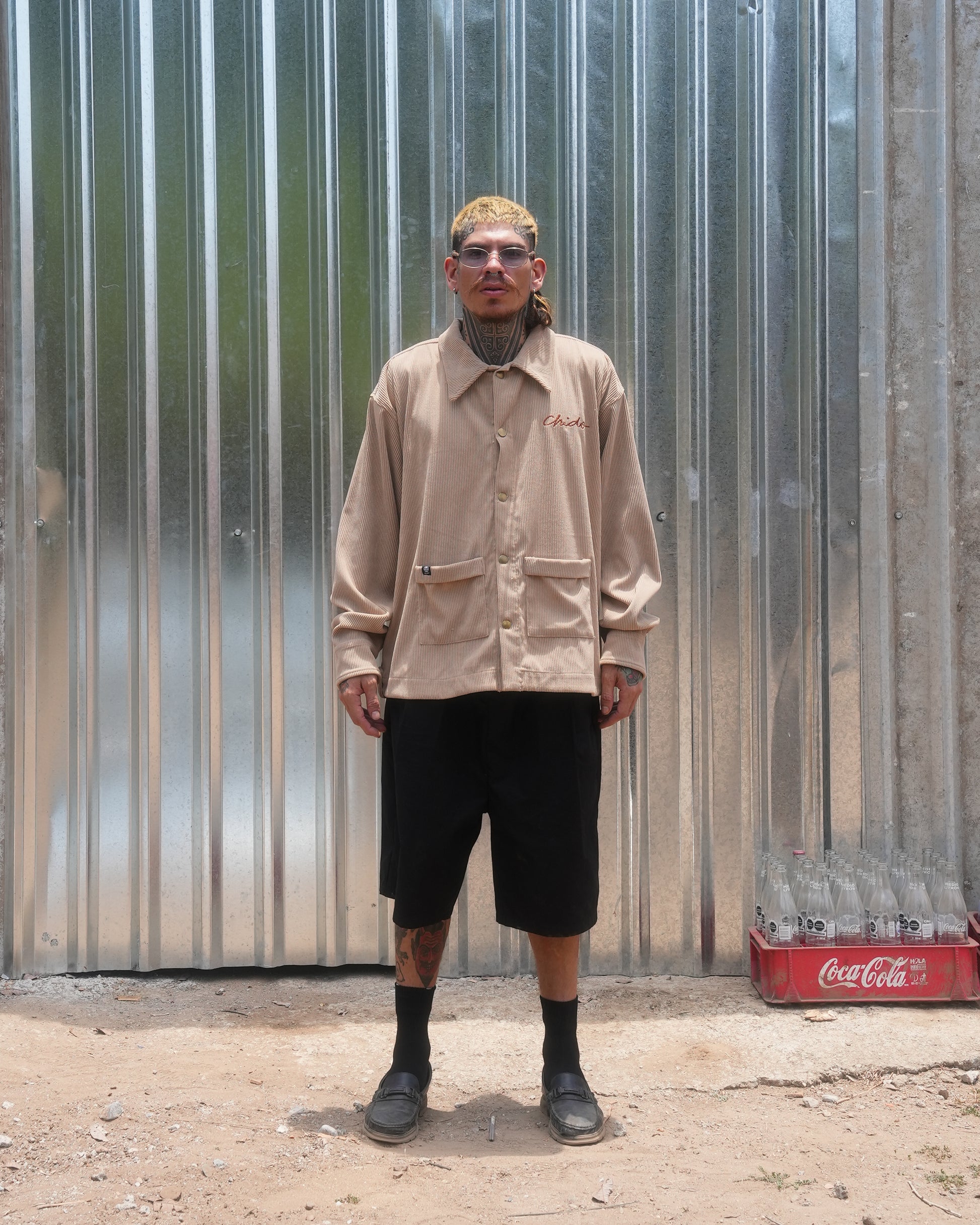 Model wearing beige corduroy jacket by CHIDO with regular fit
