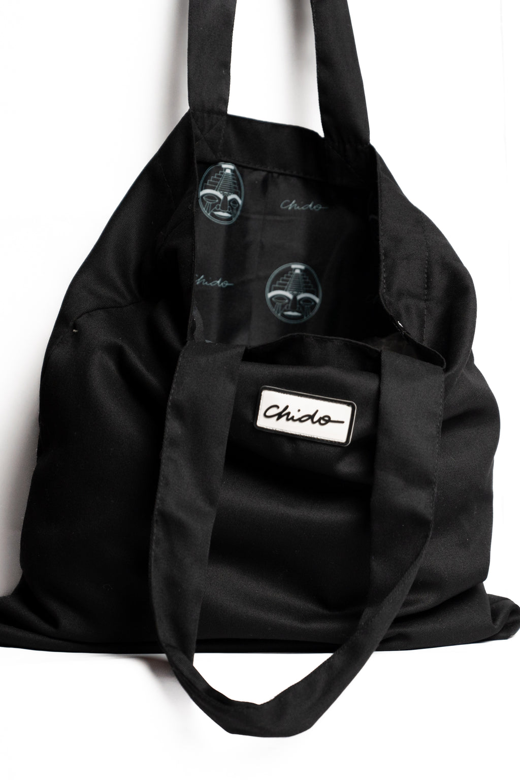 Vista lateral de la tote bag negra CHIDO de tela resistente