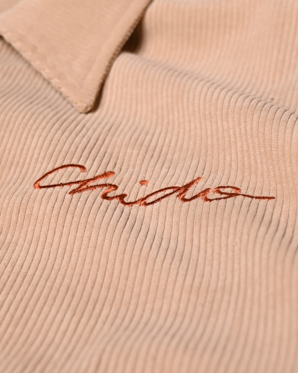 Embroidered CHIDO logo on beige corduroy jacket
