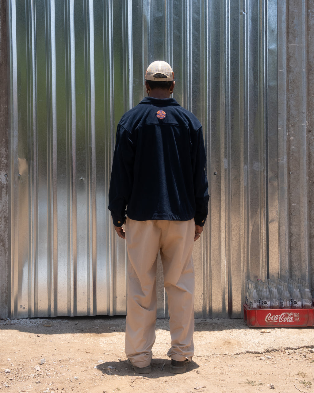 Back view of CHIDO navy corduroy chore jacket worn by model