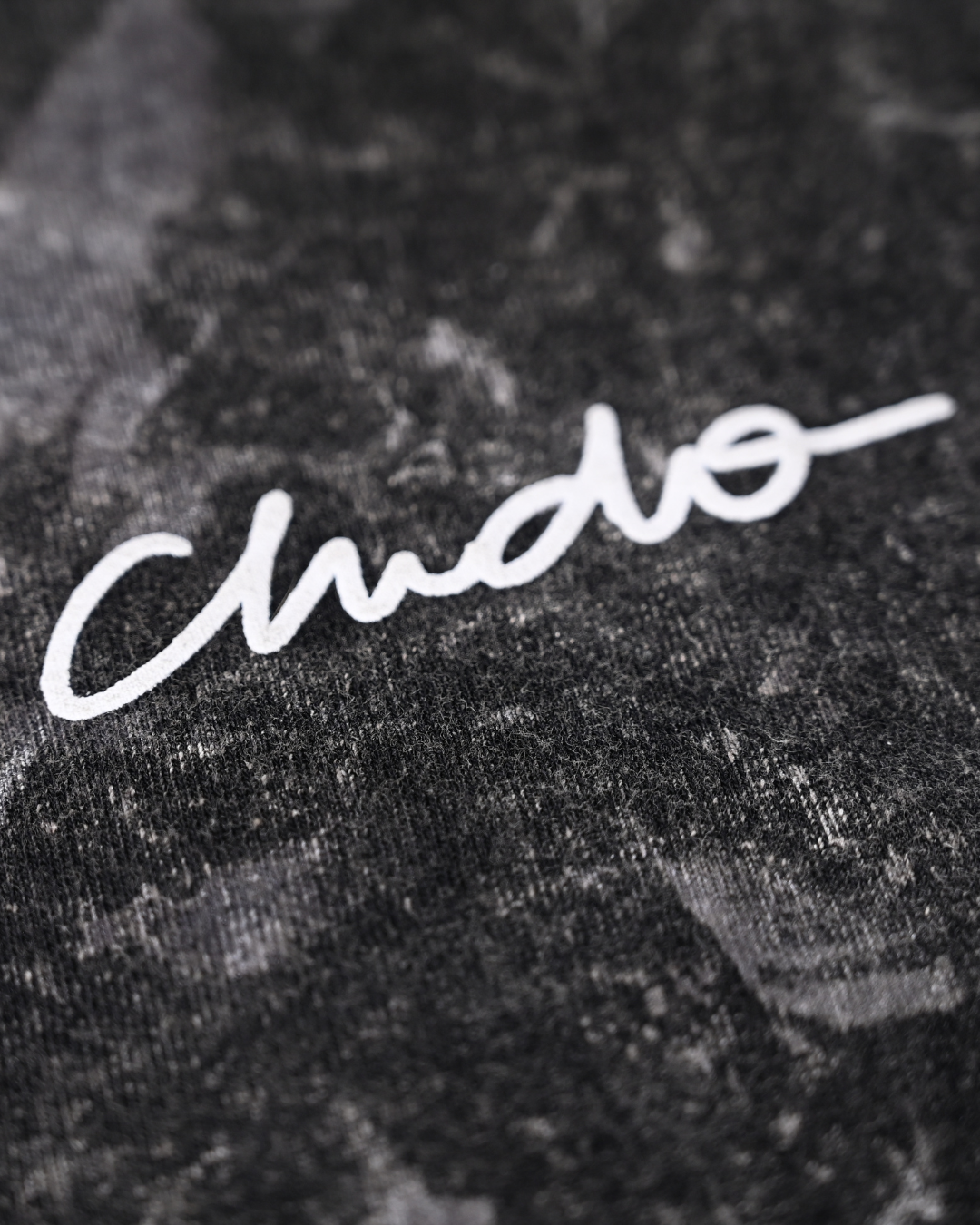 Detalle de bordado CHIDO en playera tie dye oversize negra